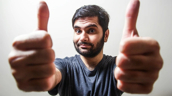 man in gray crew neck shirt making thumbs up